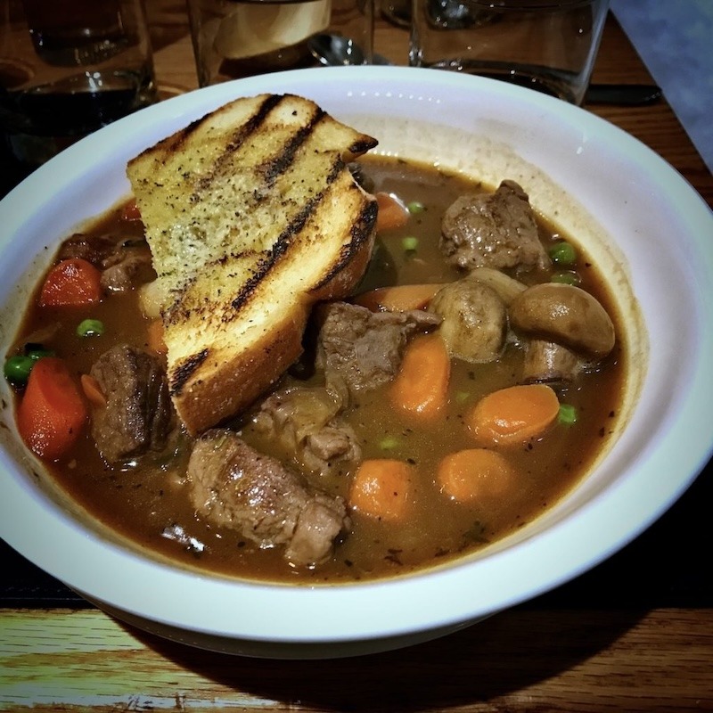 A bowl of tender beef stew prepared in a crockpot.