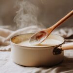 A small saucepan of smooth, creamy bechamel sauce