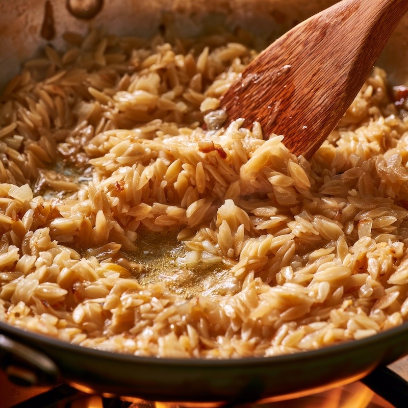 orzo toasting in butter with onion and garlic