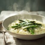 Creamy asparagus risotto in a shallow white bowl