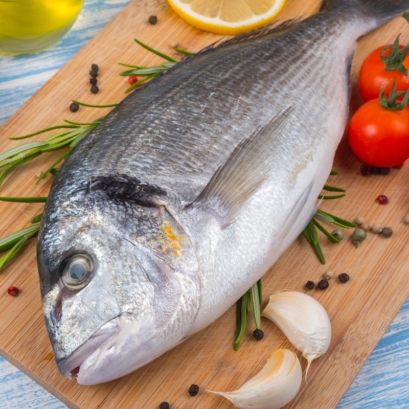 Mahi Mahi or Dorado Fish on a wooden plank.