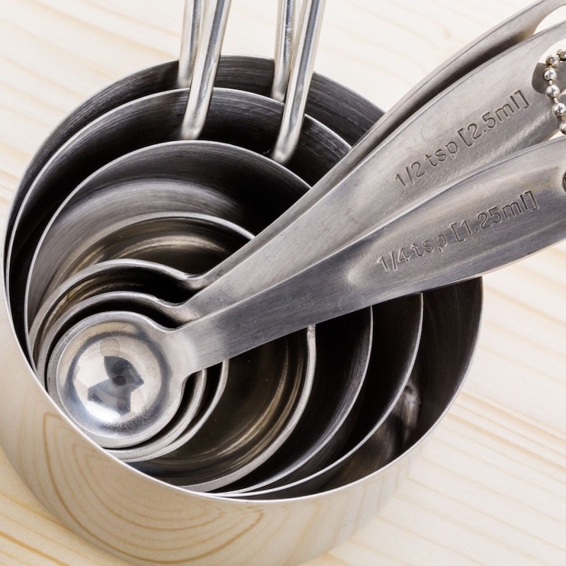 A stack of measuring cups with measuring spoons.