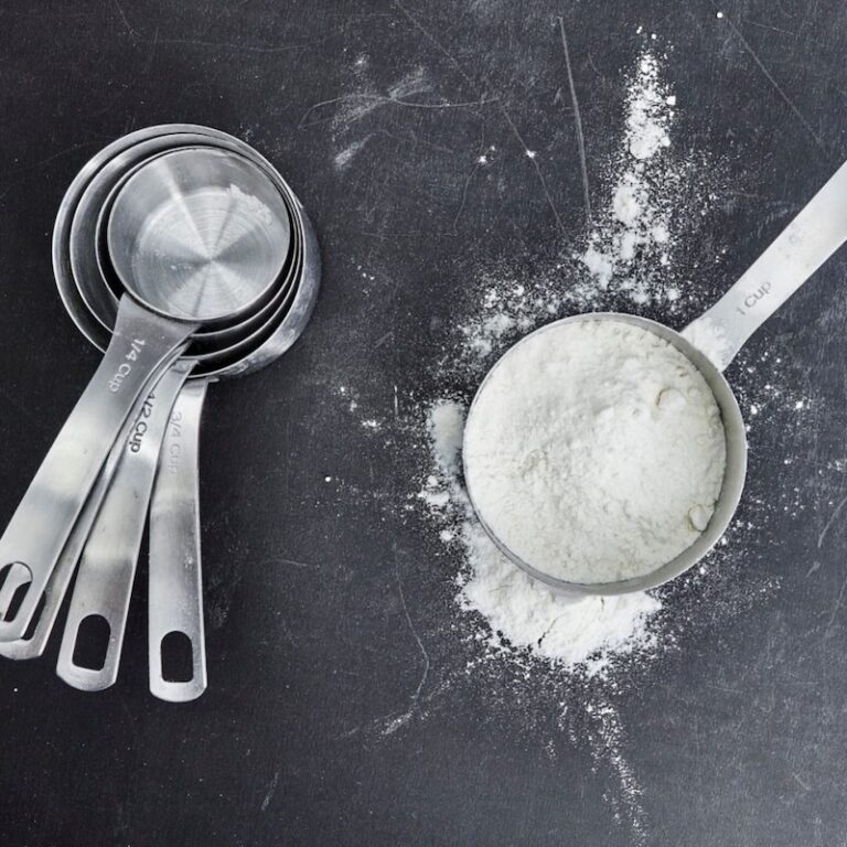 measuring cups with one filled with flour