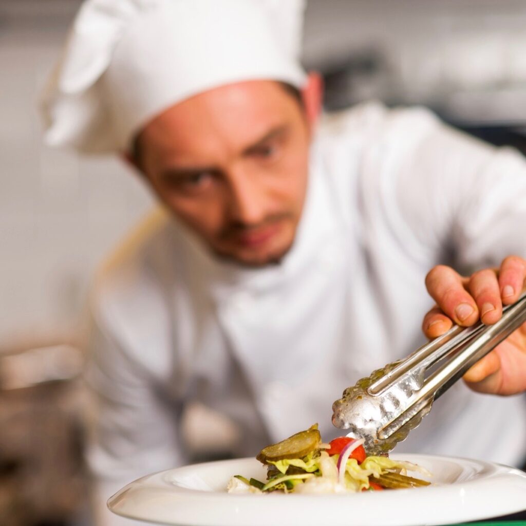 Chef with cooking tongs