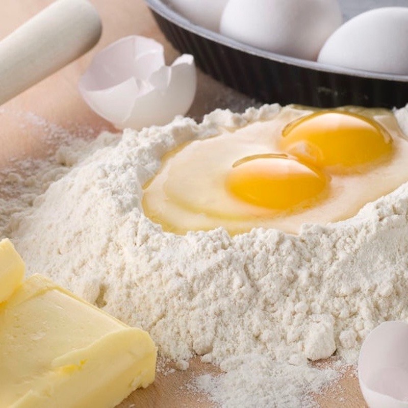 Eggs, flour and butter on countertop