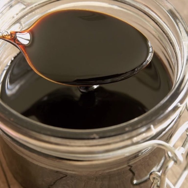 A container filled with pomegranate molasses.