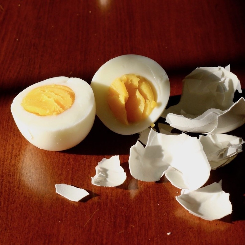 A hard boiled egg on a table fully peeled