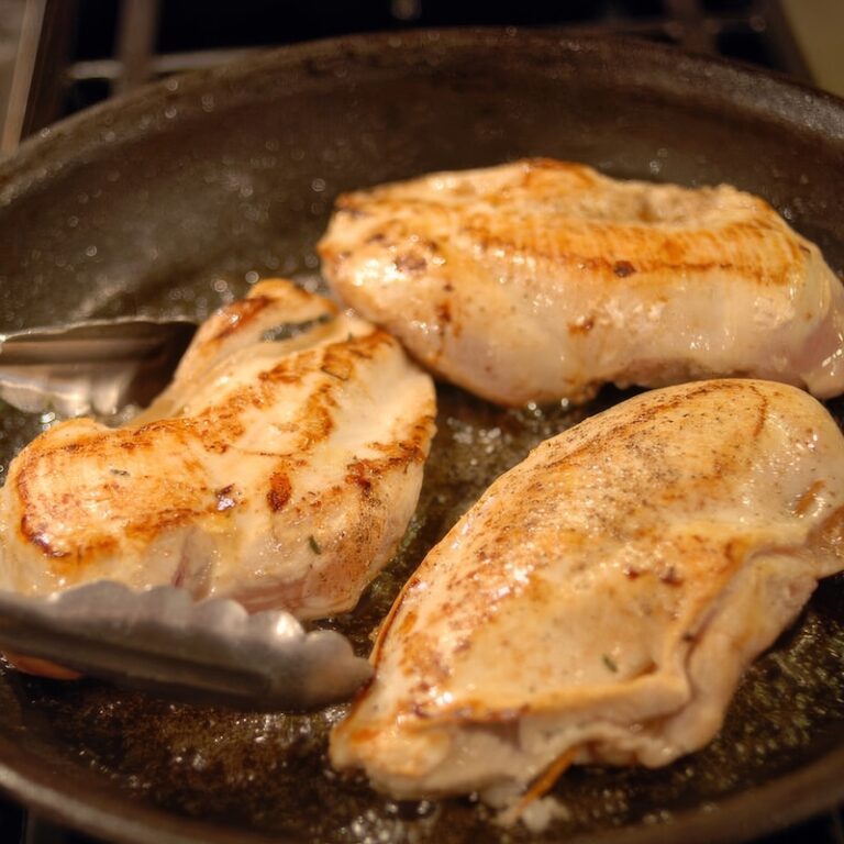 stuffed chicken breasts frying in pan