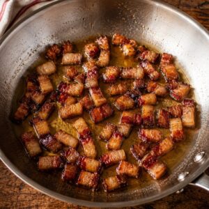 A frying pan with rendered guanciale