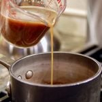 Pouring Demi Glace into Saucepan