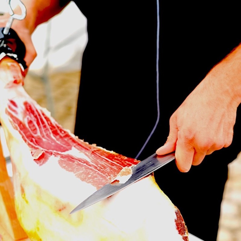 Slicing prosciutto with a sharp knife