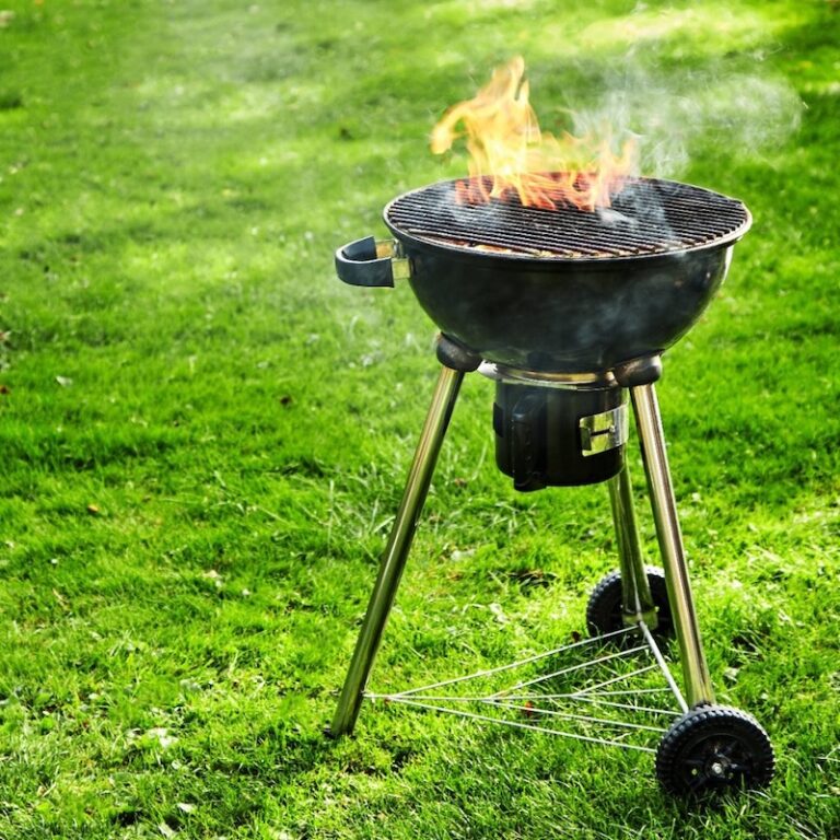 A charcoal grill in the yard