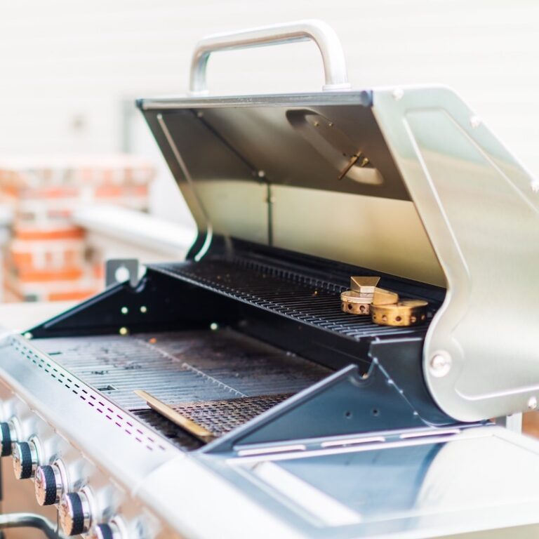 A gas grill is all shiny.