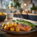 perfectly cooked salmon fillet with moist flaky texture, roasted baby potatoes with golden caramelized edges, bright green asparagus