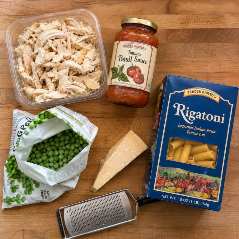Ingredients for pasta, chicken, tomato sauce, and peas