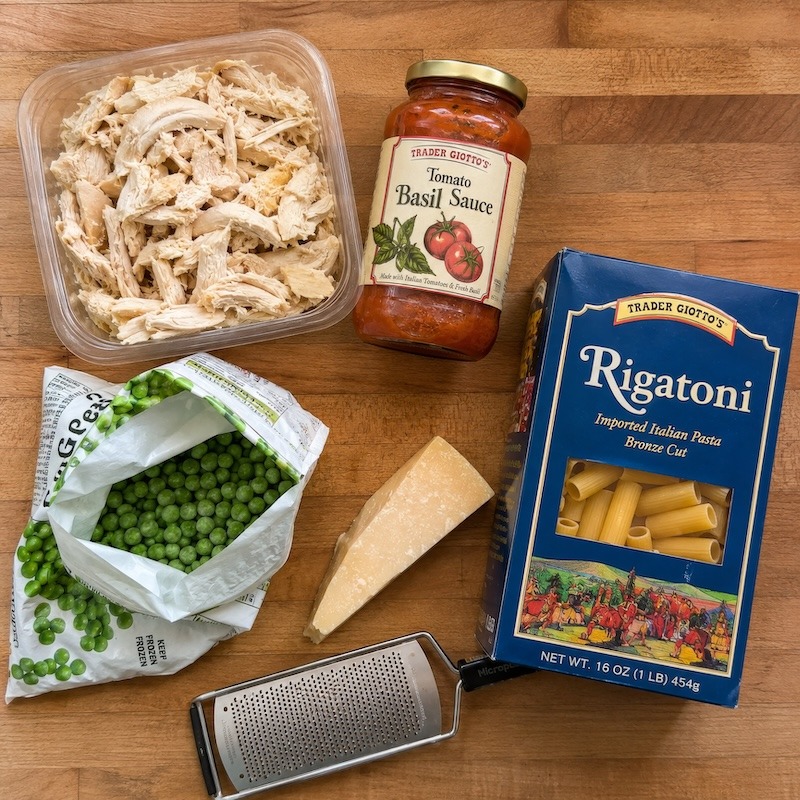 Ingredients for pasta, chicken, tomato sauce, and peas