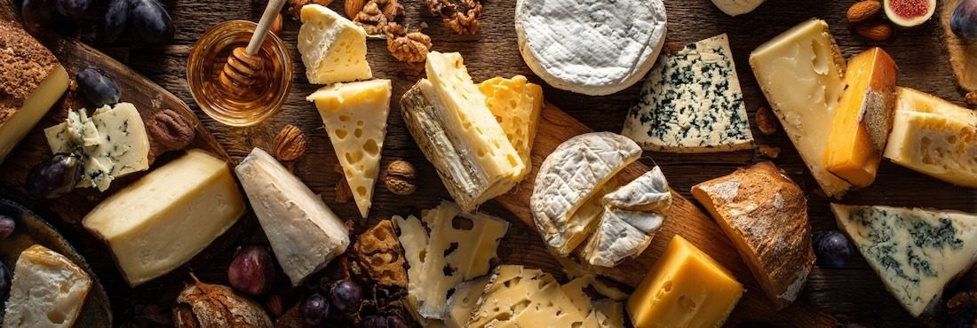 assortment of cheeses artfully arranged on a rustic wooden table